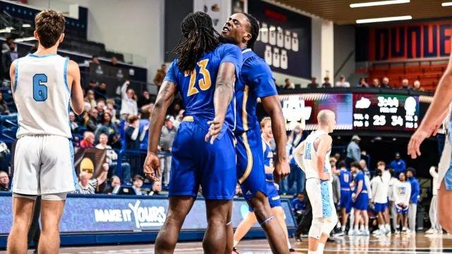 Lander chest bumps after an unthinkable DII men's basketball upset.